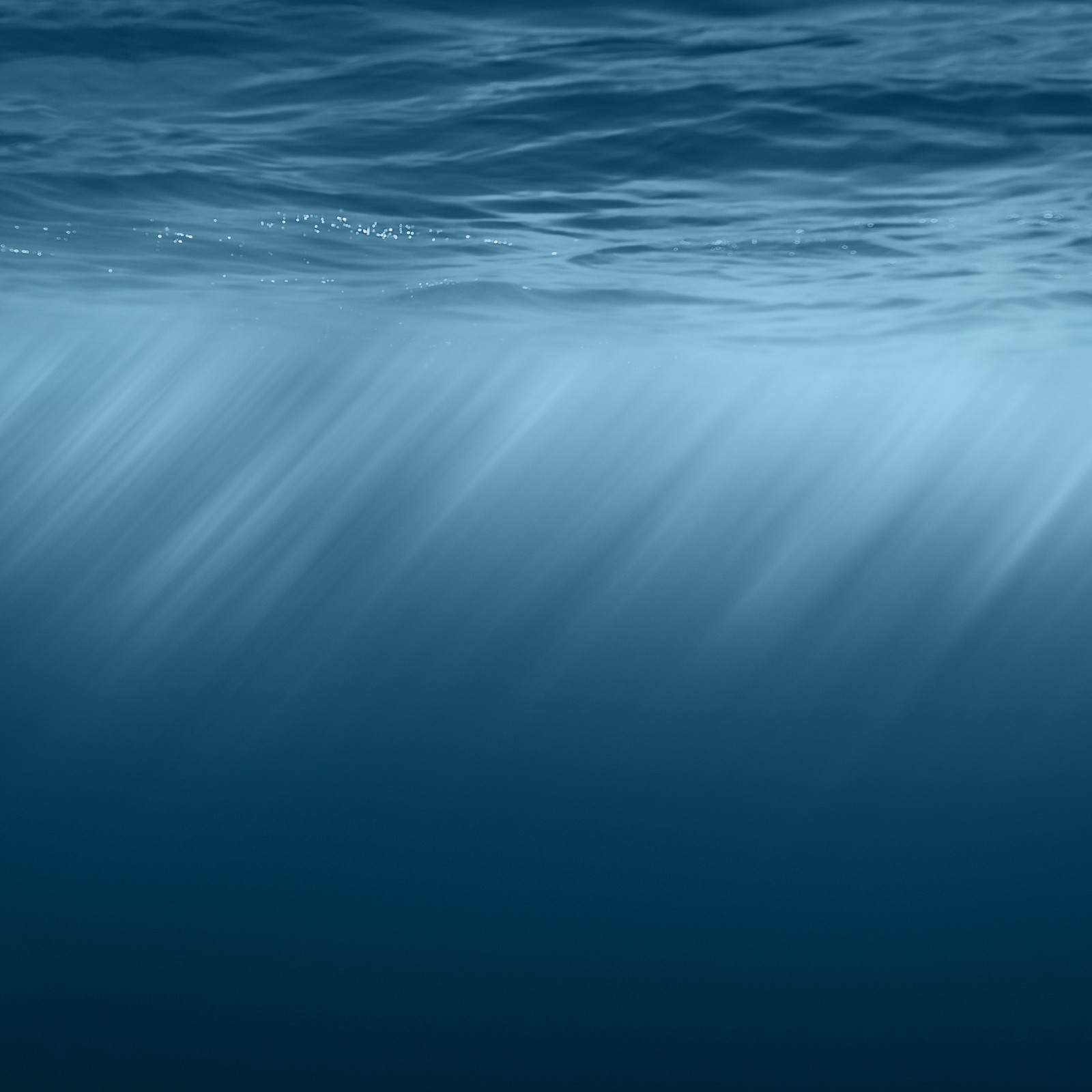 A close up of a wave in the ocean with a blue sky (ios8, ios8 official)