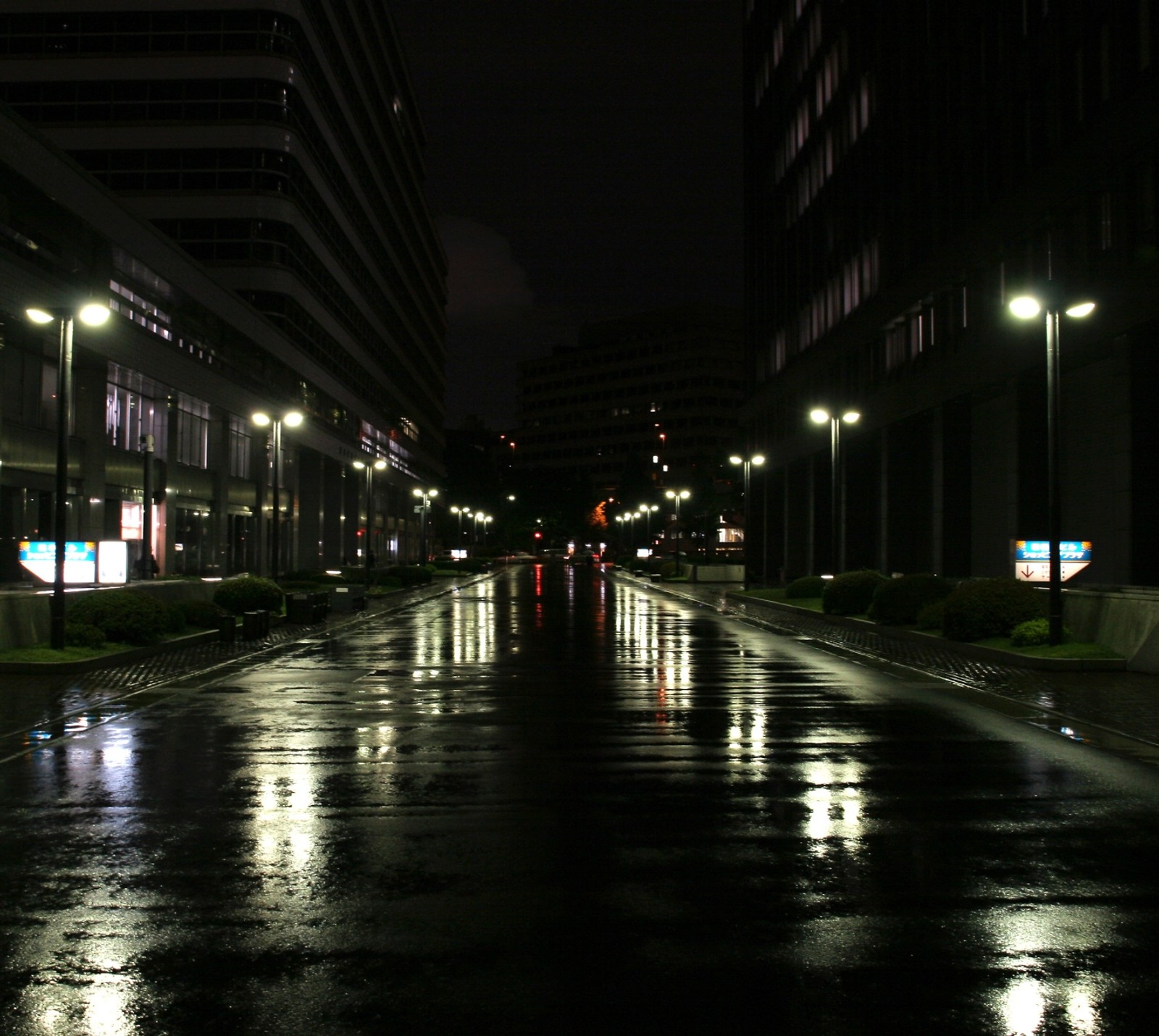 Arafficial city street at night with lights reflecting off wet pavement (black, hd, night, rain)