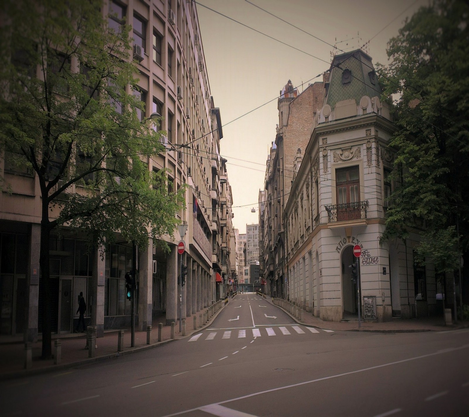 Há uma rua com prédios e uma faixa de pedestres no meio (abej, beograd, nusiceva, opstina, politika)