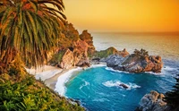 Serene Coastal Cove at Sunset with Lush Palm Trees and Rocky Cliffs