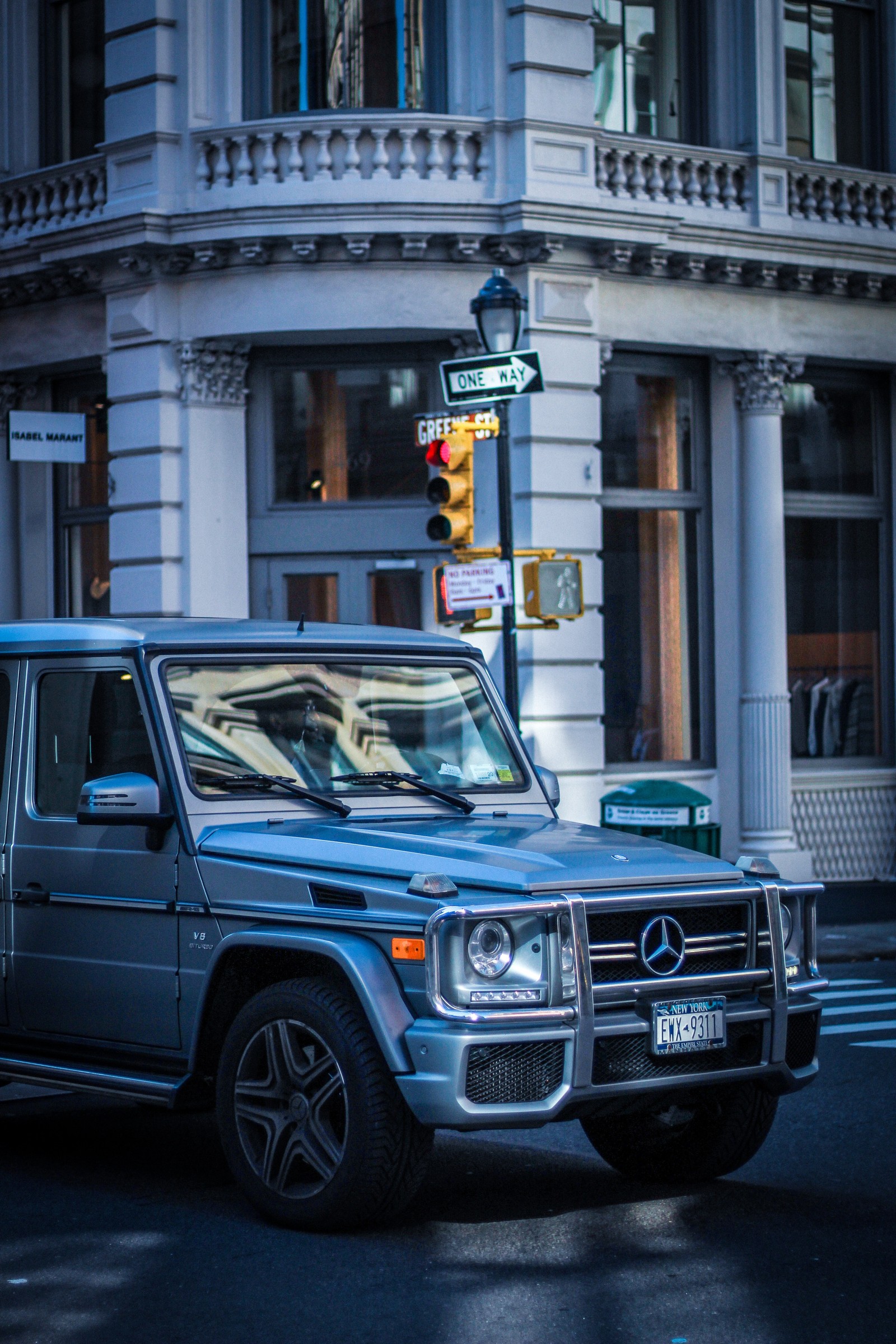 Arafed mercedes g - class parked on a city street (car, jeep, wheel, automotive tire, transport)