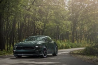 2023 Ford Shelby Mustang Boss 429 on a winding forest road.