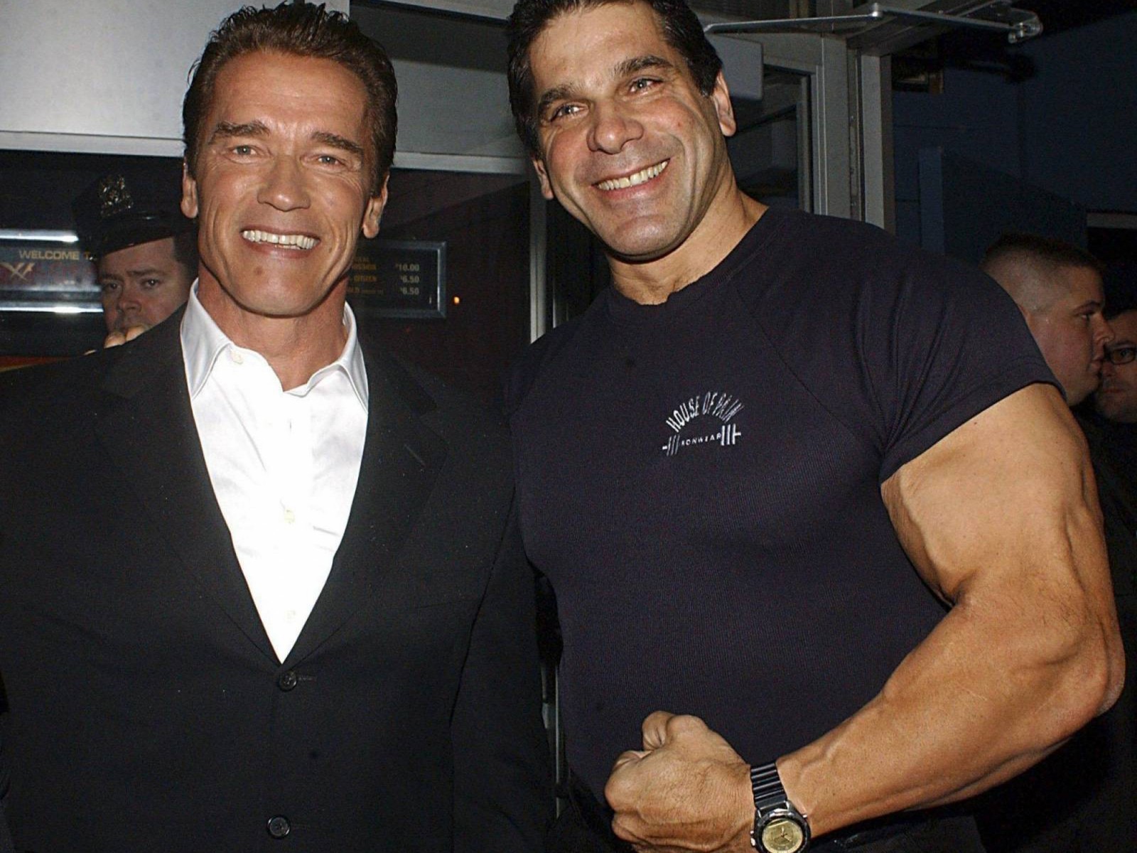 Arafed man in a black shirt and a man in a black suit (arnold schwarzenegger, actor, bodybuilding, muscle, arm)