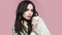 Sofia Carson: Captivating Elegance in a Chic White Ensemble on a Soft Pink Background