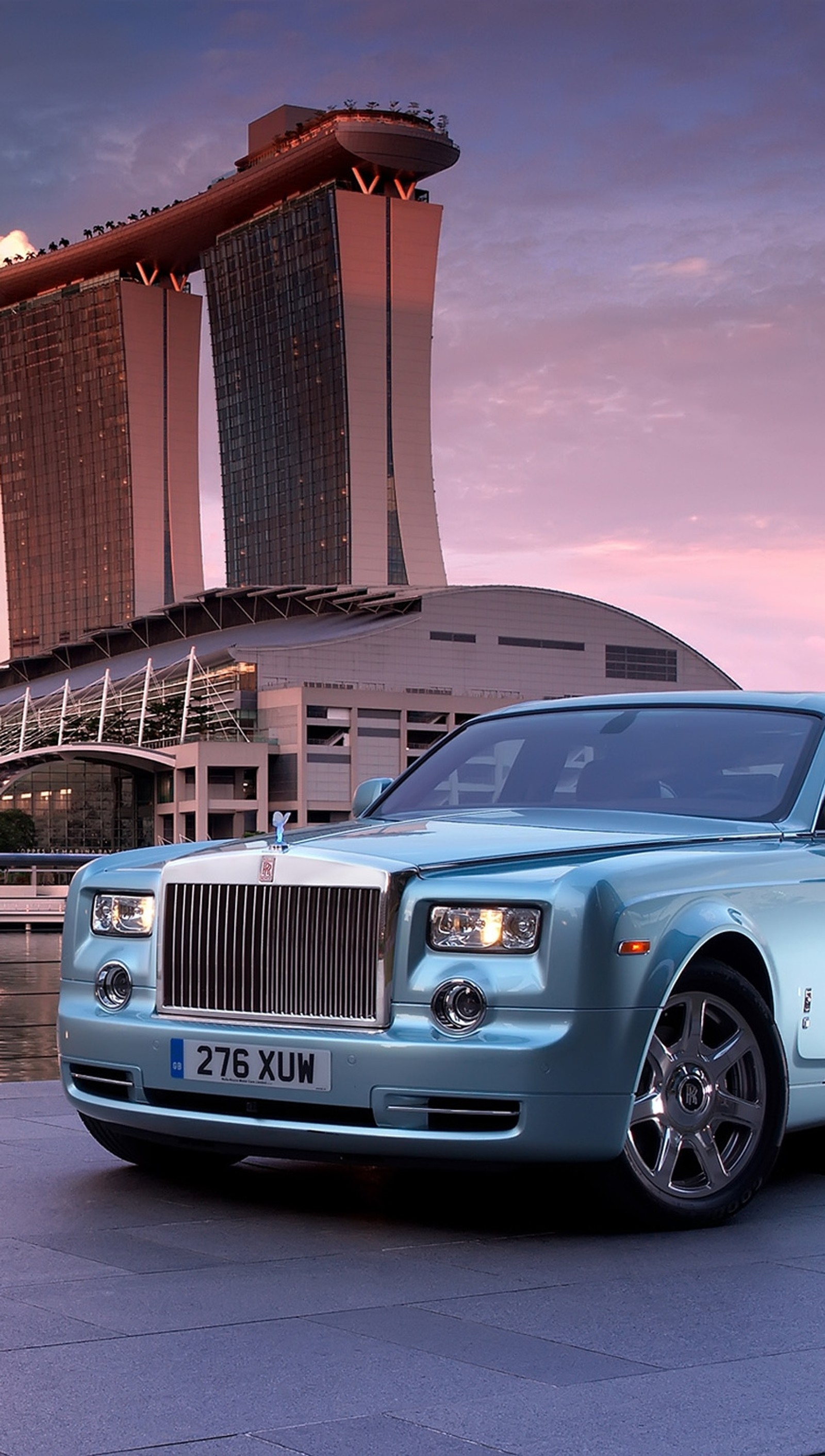 A close up of a blue rolls royce parked in front of a building (car, luxury, phantom, rolls royce)