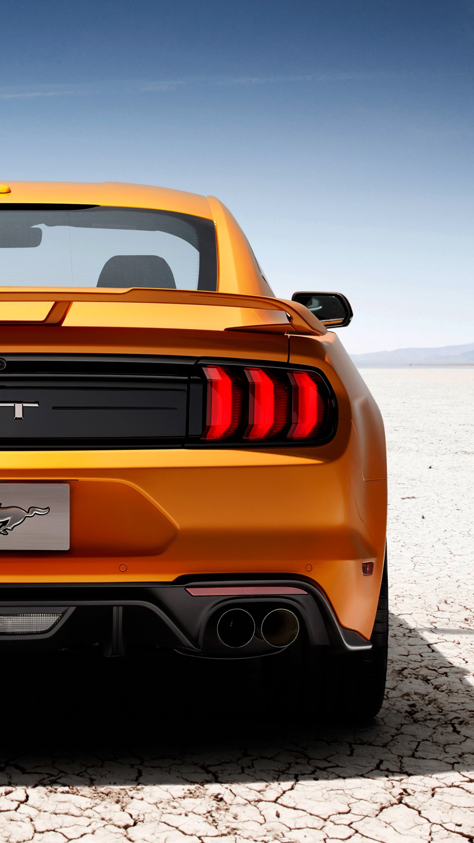 A close up of a yellow sports car parked in a desert (american, engine, ford, gt, muscle)