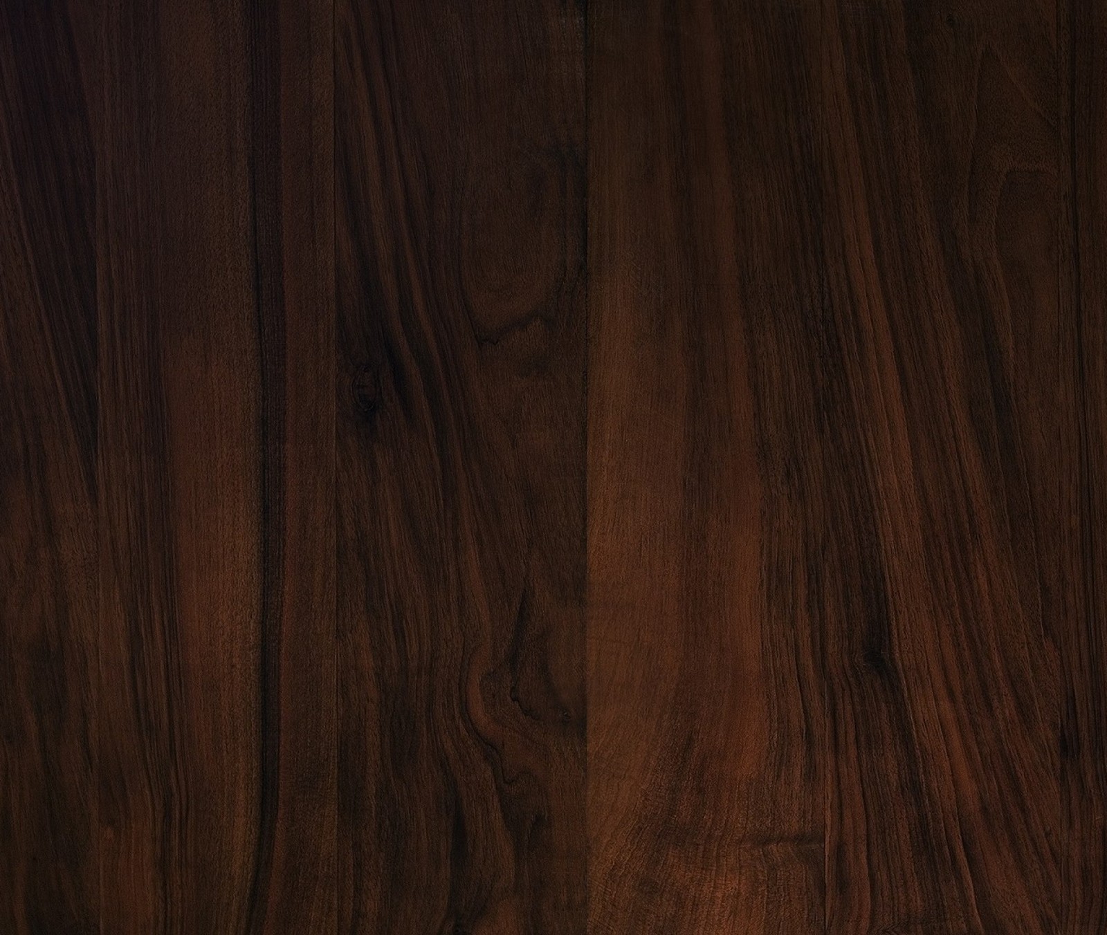 A close up of a wooden floor with a brown stain (meem, rubab)