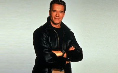 Arnold Schwarzenegger em uma jaqueta de couro preta, exibindo uma postura confiante com os braços cruzados, incorporando o carisma de Hollywood.