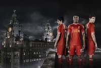 Liverpool FC Players in Iconic Red Kit Against a Dramatic Cityscape