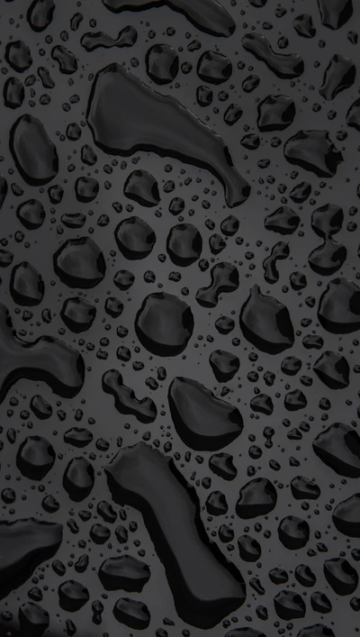 Dark Surface Adorned with Glimmering Water Droplets