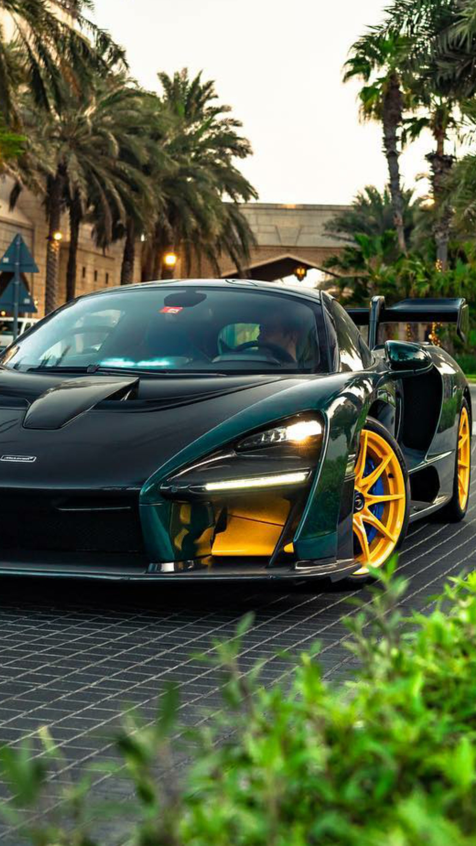 A close up of a green and yellow sports car parked on a street (mclaren, senna, green, car, hypercar)