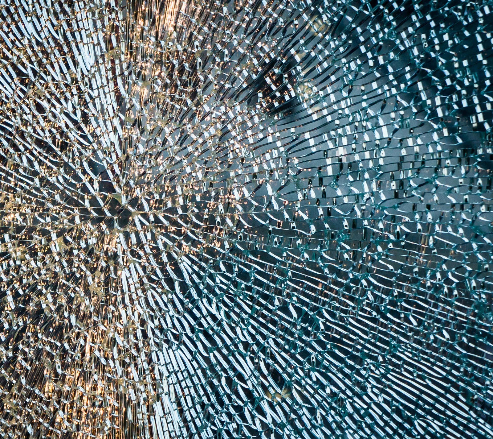 A close up of a broken glass window with a lot of small holes (broken, glass, macro, texture)