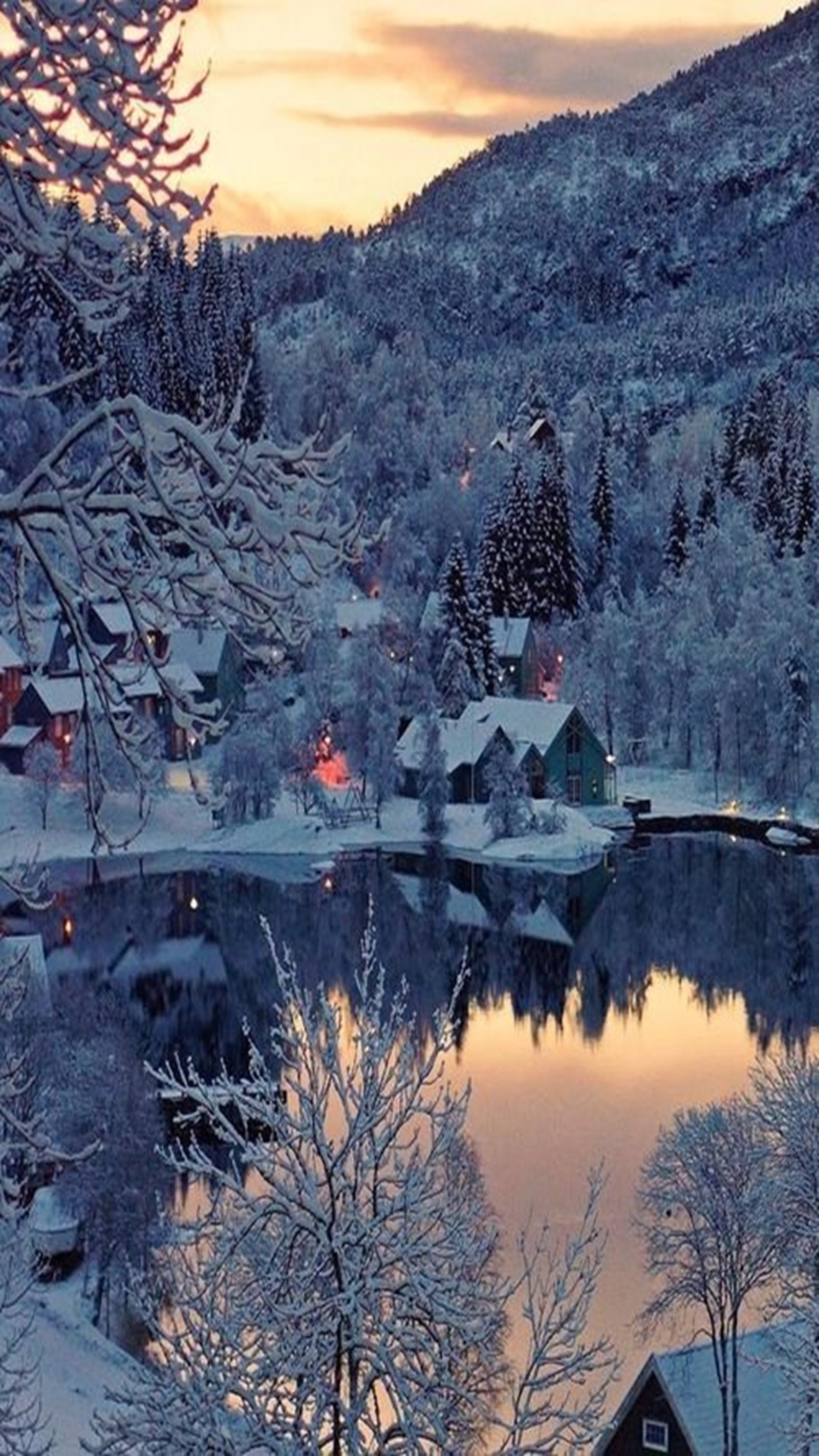 Snowy scene of a small village with a lake and a mountain in the background (landscape, snowy)