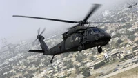 Sikorsky S-70 Black Hawk Military Helicopter in Flight Over Urban Landscape