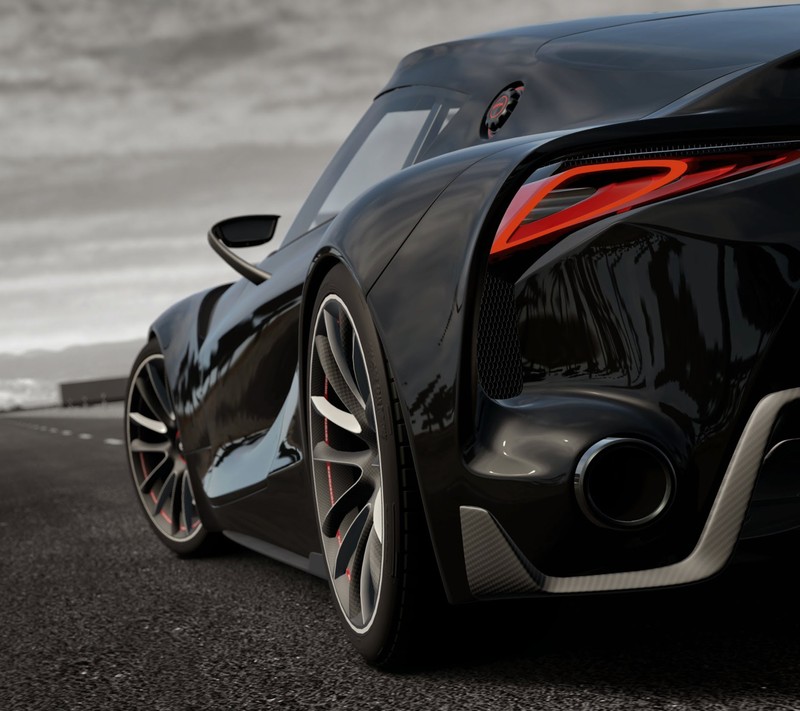 A close up of a black sports car on a road (black, car)