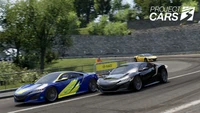 Intense racing action in Project Cars 3 featuring sleek sports cars on a winding track.