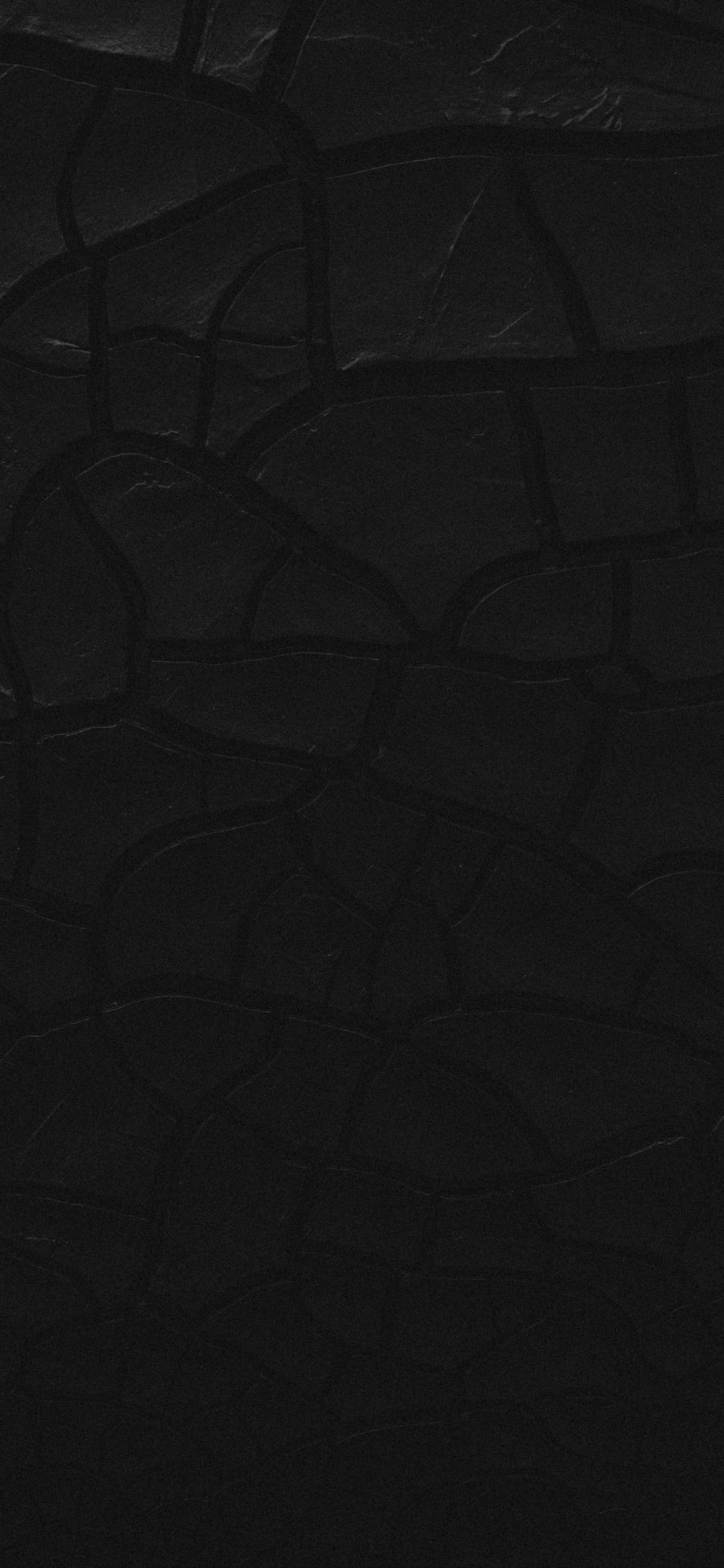 A close up of a black wall with a clock on it (light, physics, science, automotive tire, sleeve)