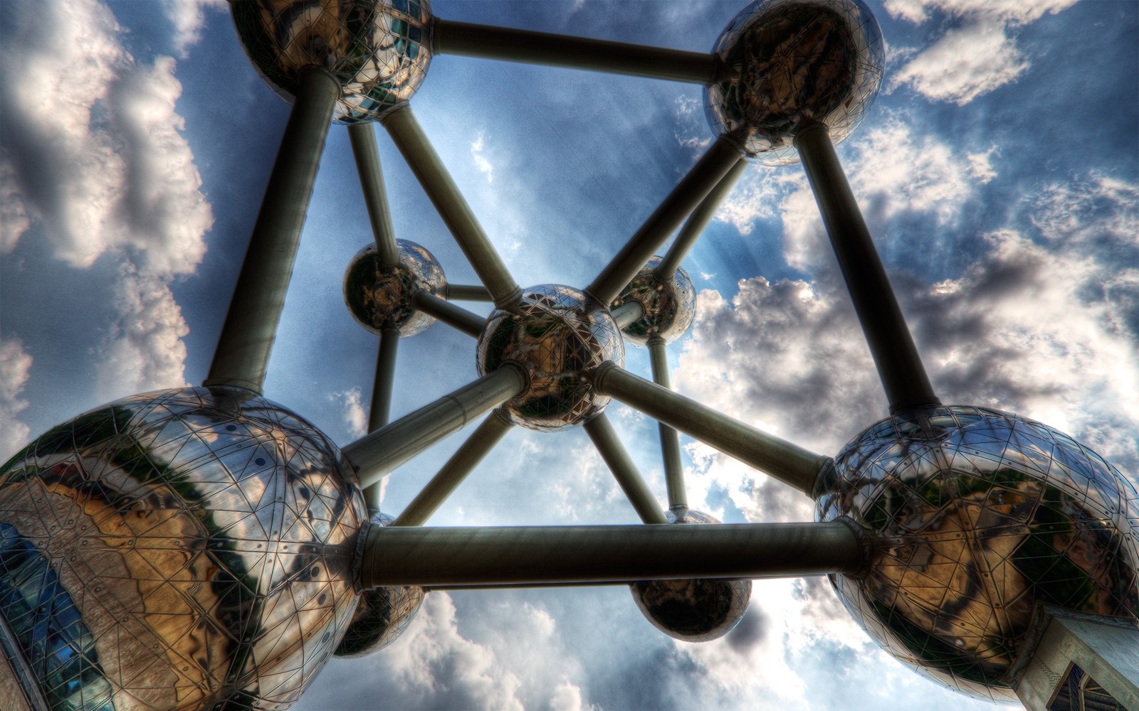 Arafed view of a group of spheres with a sky background (architecture, cloud, metal)