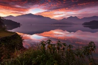 Sereno lago de montaña al amanecer con majestuosas reflexiones