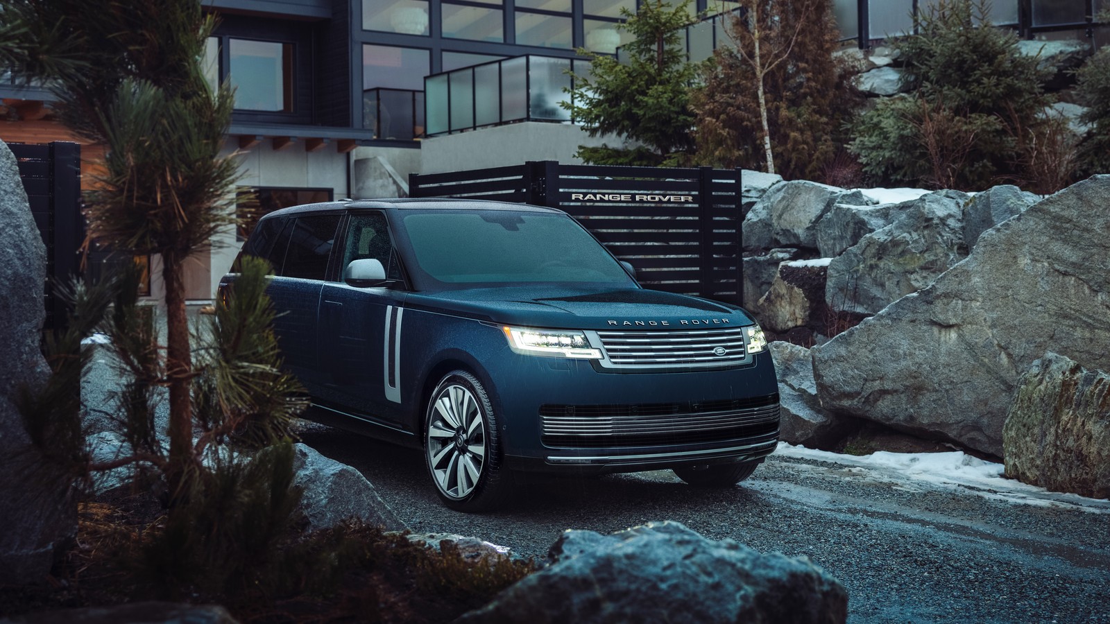 A blue range rover parked in front of a building with a mountain in the background (range rover sv, 2024, 5k, 8k, cars)