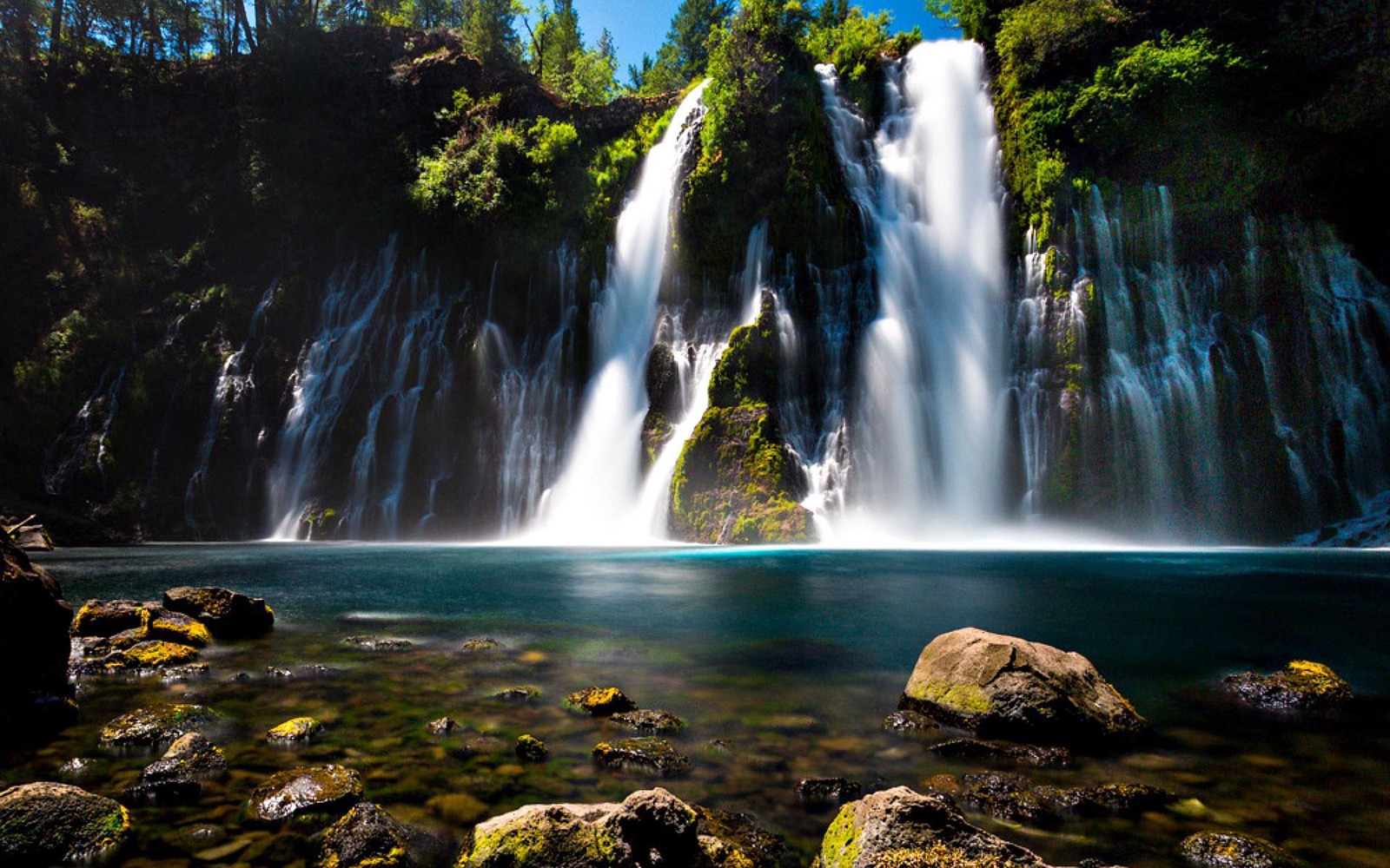 A waterfall in the middle of a forest with rocks and water (burney falls, waterfall, body of water, nature, water resources)