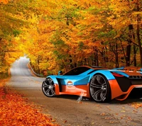 Un vibrante coche deportivo con la librea Gulf estacionado en una carretera sinuosa rodeada de follaje otoñal.