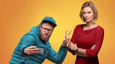 Seth Rogen and Charlize Theron in a playful movie promotional shot.