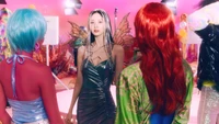 Seohyun in a vibrant, fantastical setting, adorned with butterfly wings and surrounded by colorful, stylish figures, embodying the enchanting theme of "Cosmic Festa.