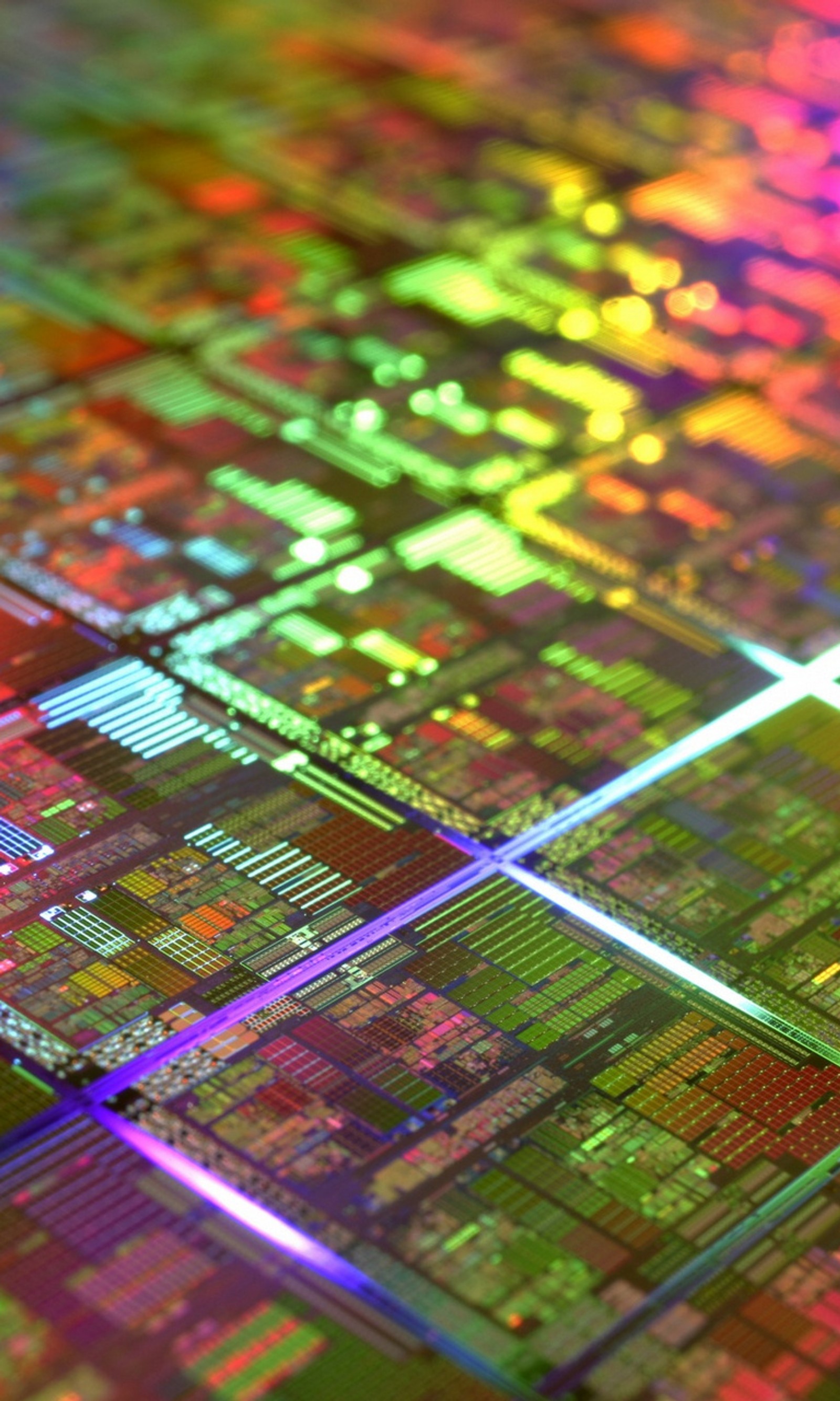 A close up of a computer chip with a rainbow light (chips, computer, electronics, silicon)