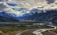 Majestic Highland Valley with Meandering River and Dramatic Mountain Backdrop