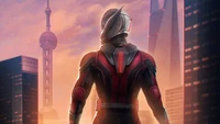 Ant-Man in a dynamic cityscape at sunset, poised for action.