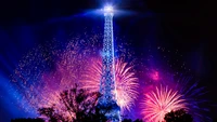 Eiffel Tower Illuminated by Colorful Fireworks in Paris Night Sky