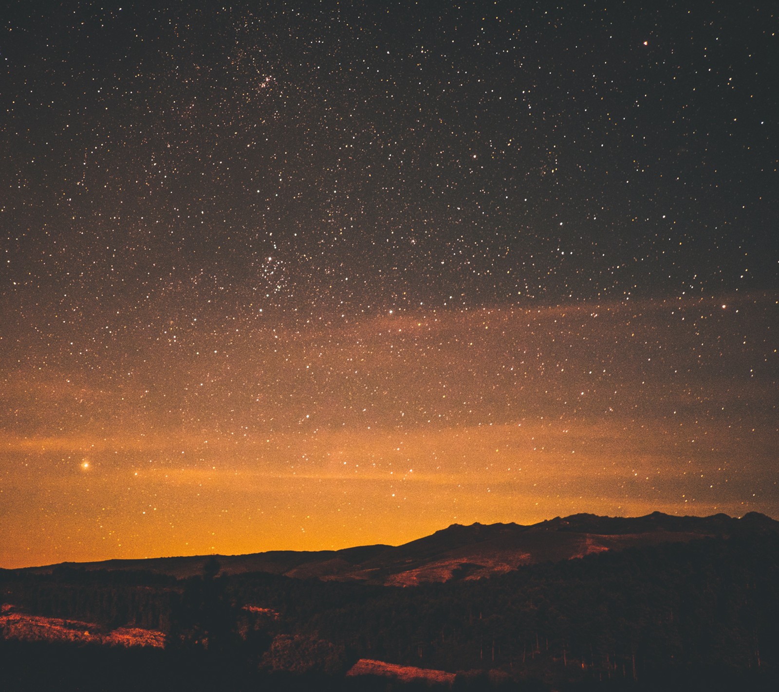 A view of a mountain with a sky full of stars (landscape, night, sunset)