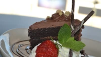 Decadent Flourless Chocolate Cake with Whipped Cream and Fresh Strawberry