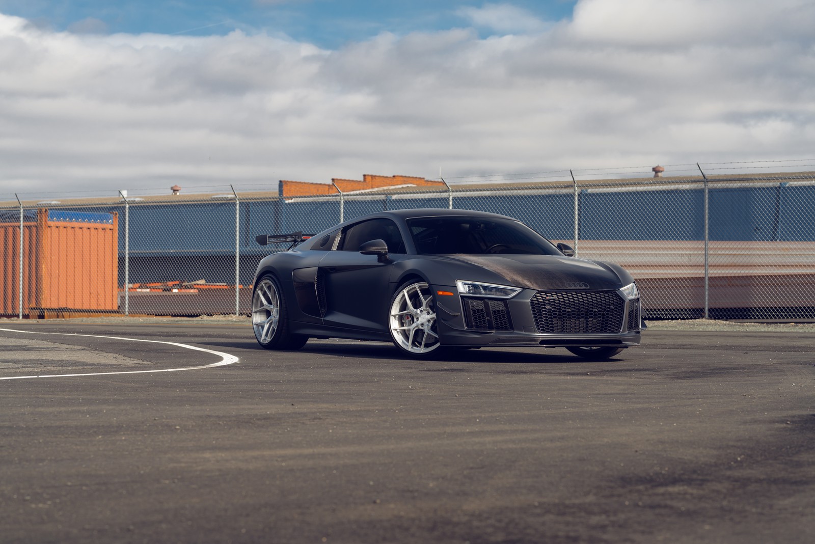 Arafed sports car parked in a parking lot with a fence in the background (audi r8, sports car, cars, 4k wallpaper)