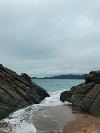 Serene Coastal Scene with Rocky Shores and Gentle Waves