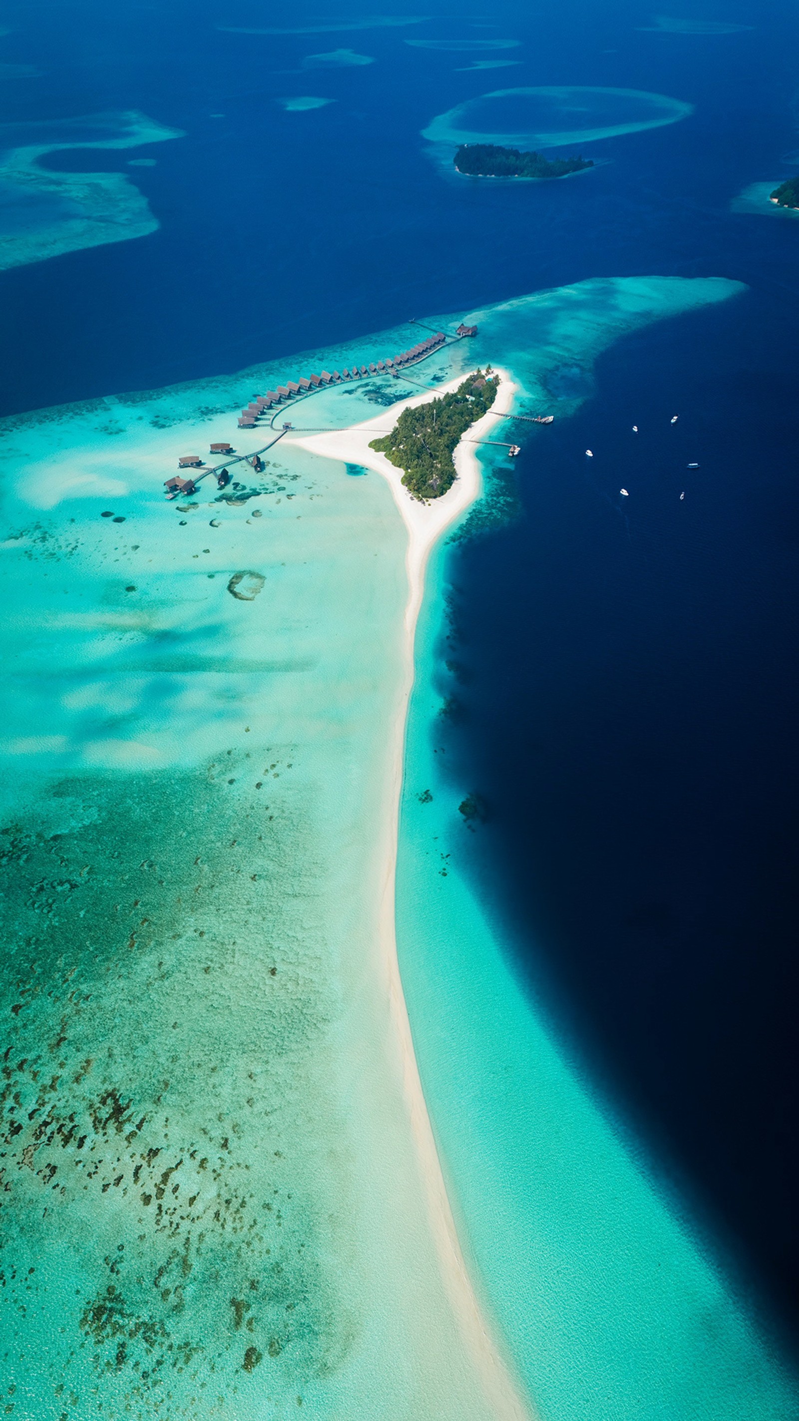 Uma vista aérea de uma praia de areia e uma lagoa com uma praia de areia branca (ilha, férias, atol, estância, viagem)