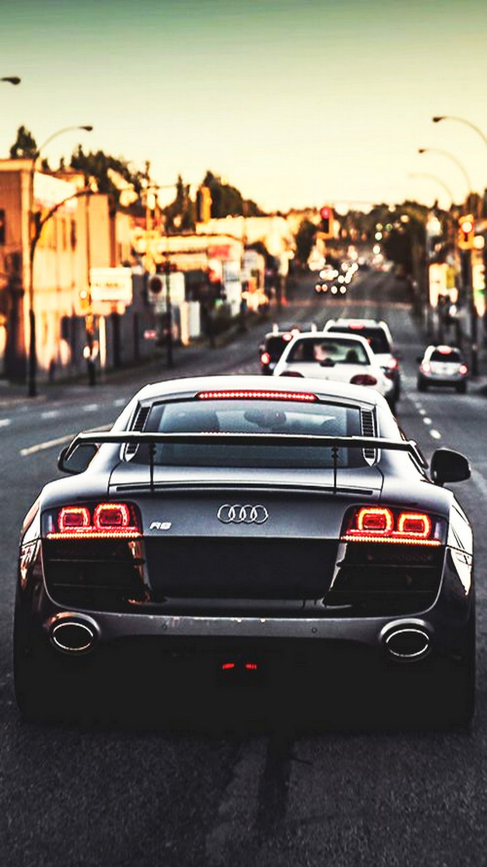 Cars driving down a street with a lot of traffic on it (audi, audi r8, black)