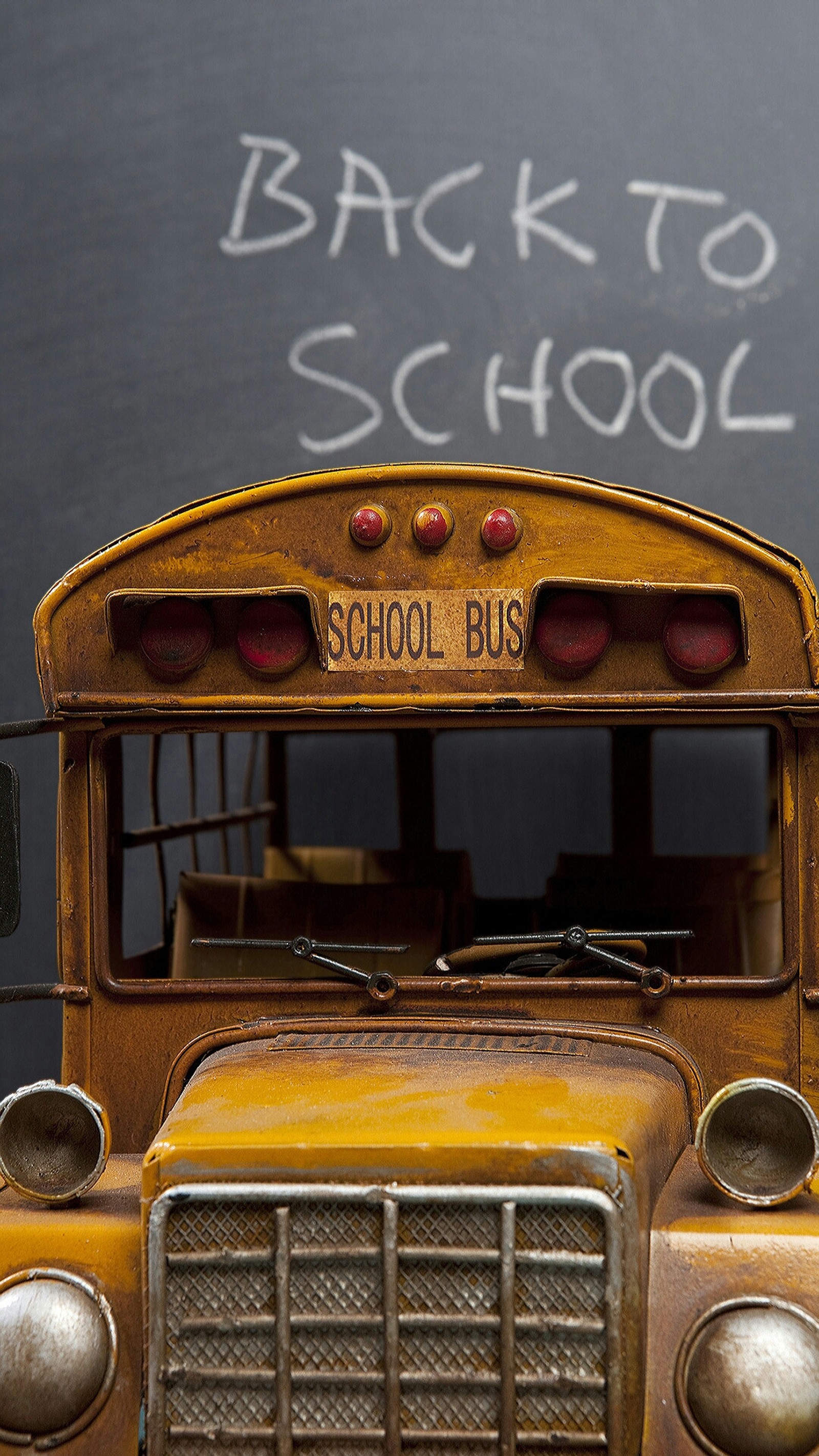 There is a yellow school bus with a chalk board in the back (auto, autobus, bus, school, yellow)