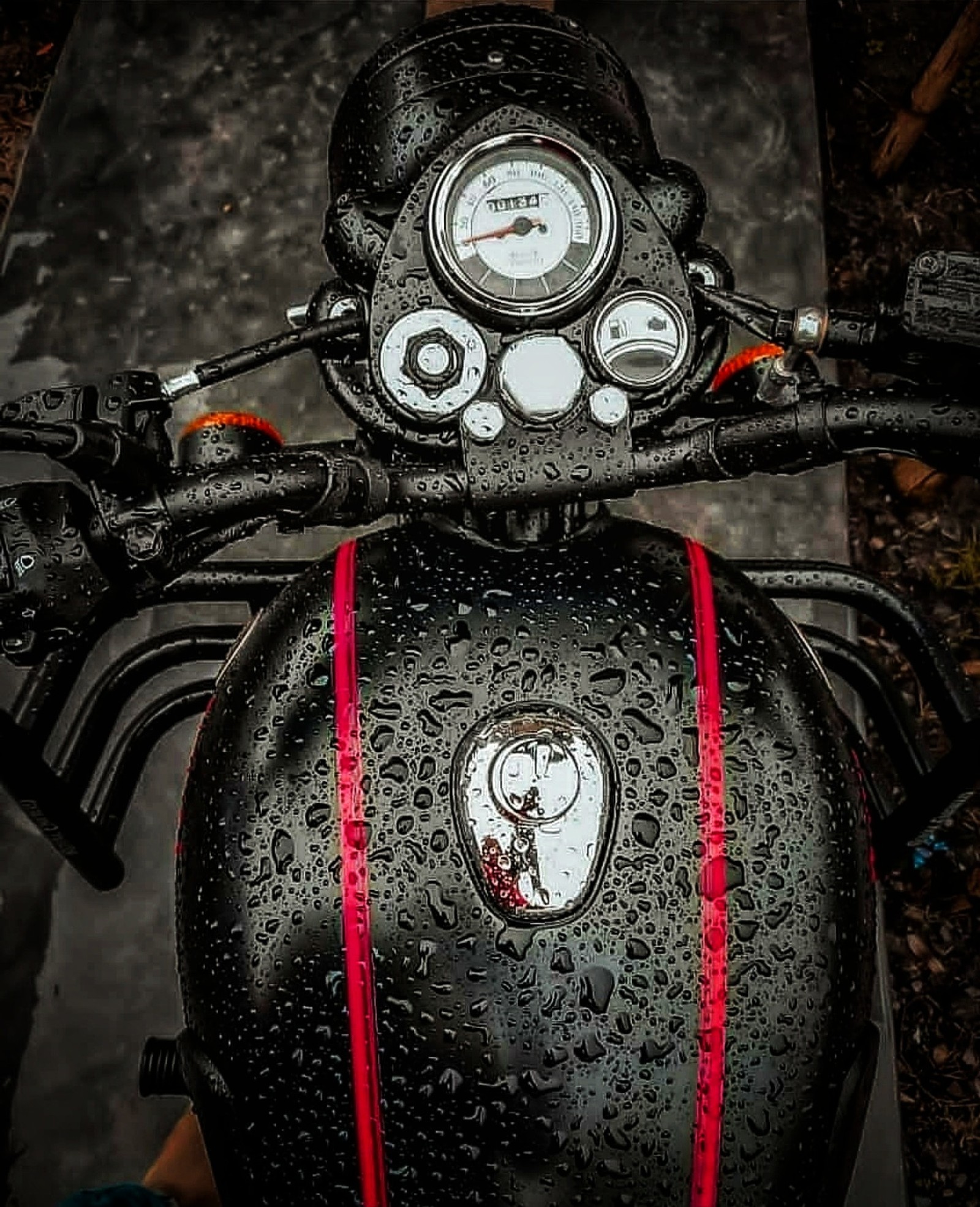 A close up of a motorcycle with a clock on the handlebars (bike, bikes, black, bullet, rider)