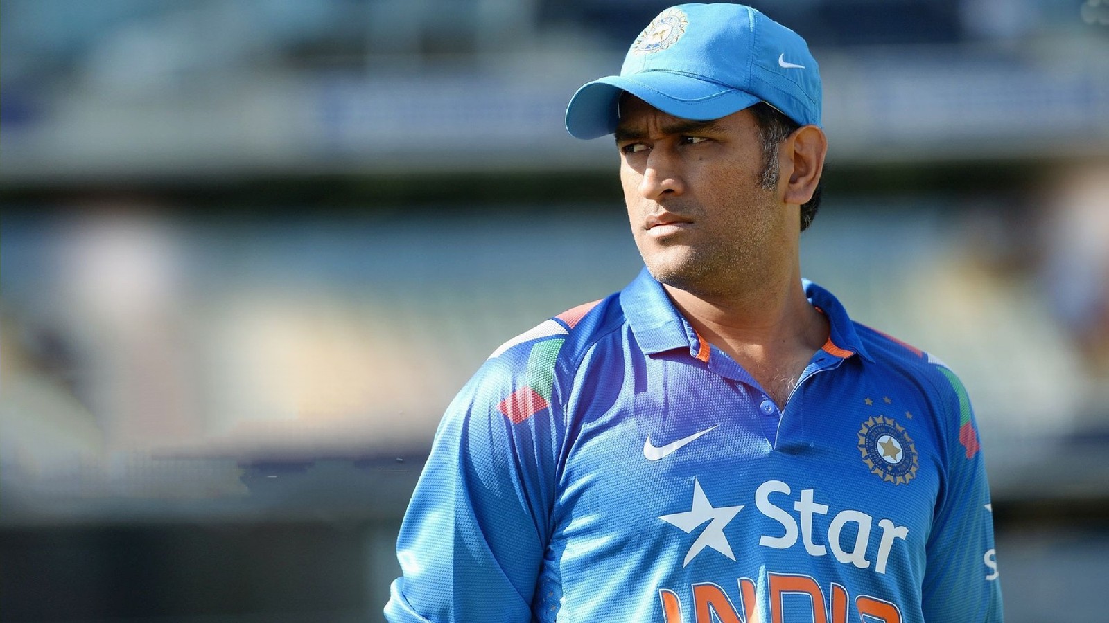 A close up of a man in a blue shirt and hat (captain cool, cricket, csk, dhoni, india)