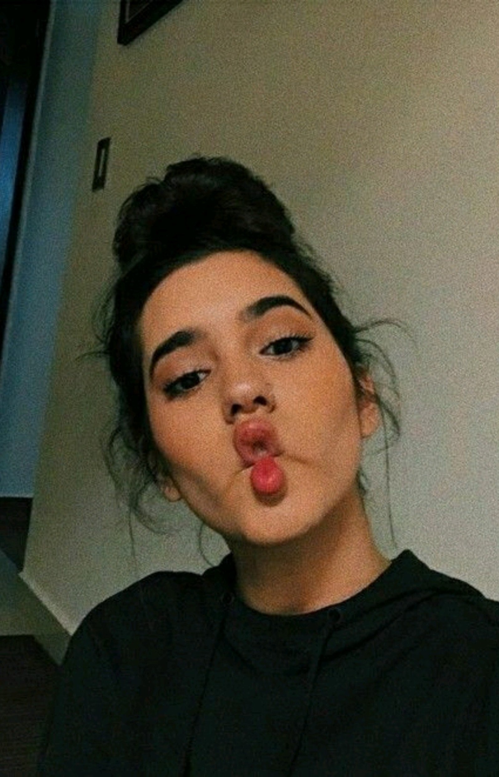 There is a woman making a funny face with her tongue (domelipa, tiktok, tumblr)