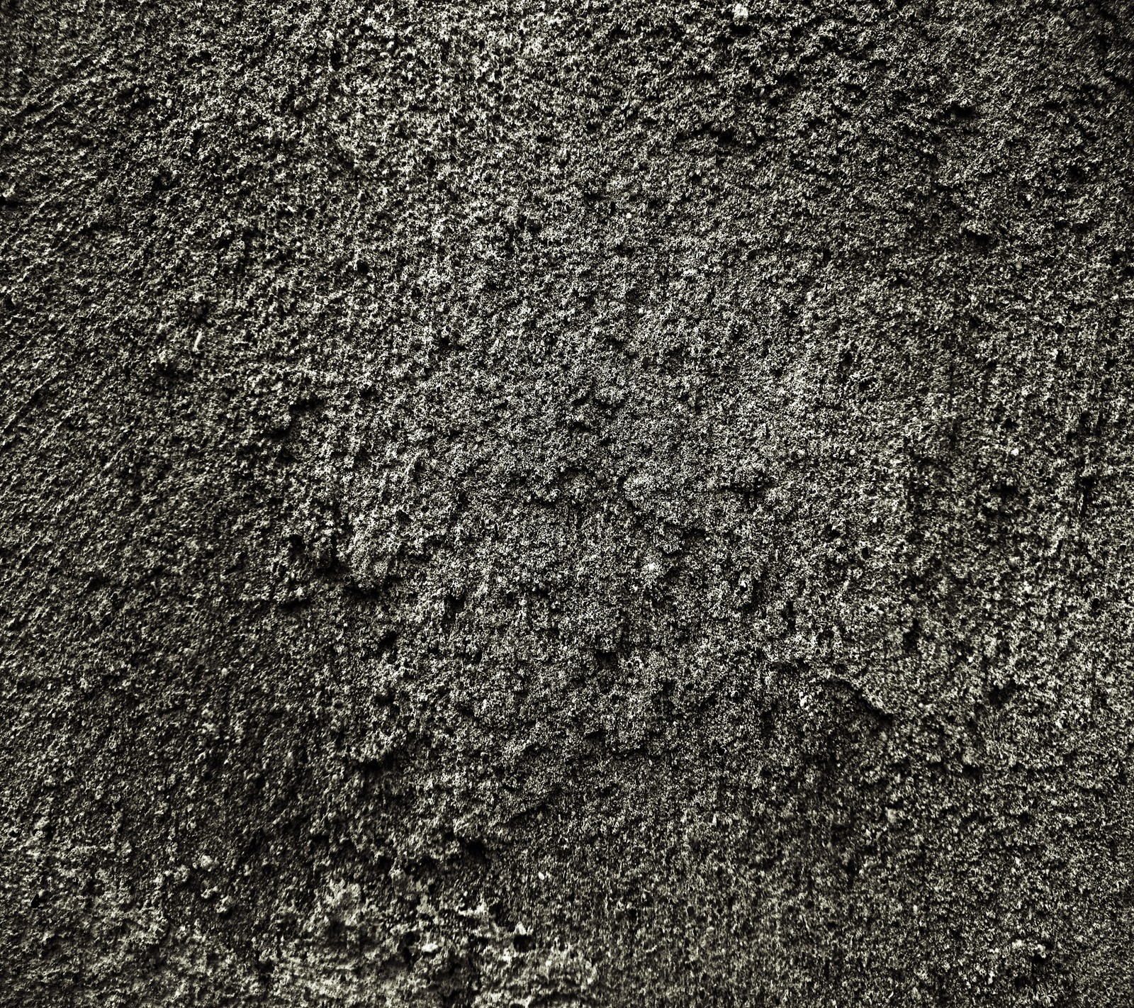 A close up of a black and white photo of a wall (texture, wall)