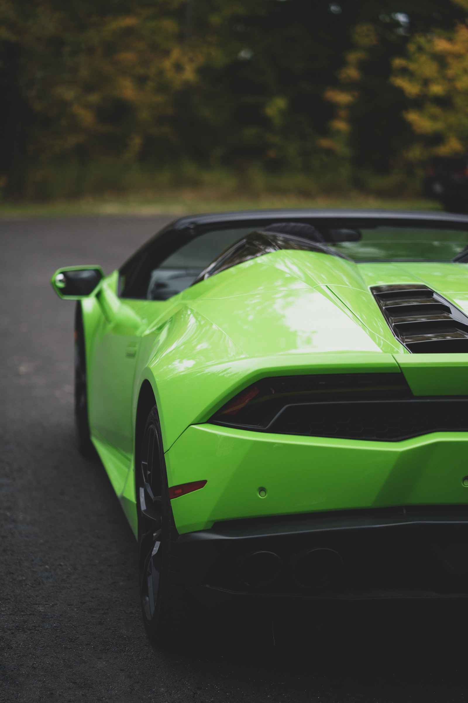 A close up of a green sports car parked on a street (lamborghini aventador, lamborghini, hood, supercar, lamborghini murcilago)