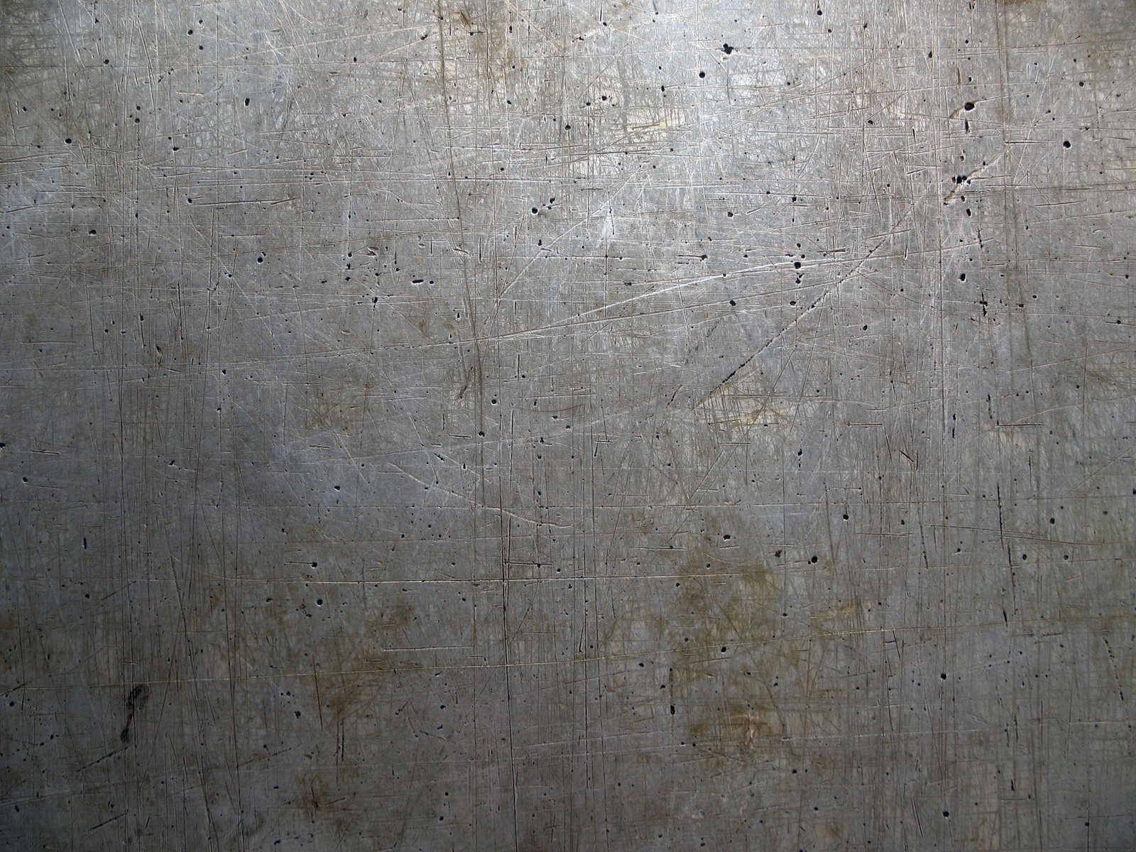 Arafed metal surface with a lot of holes and scratches (wall, cement, concrete, wood, texture)