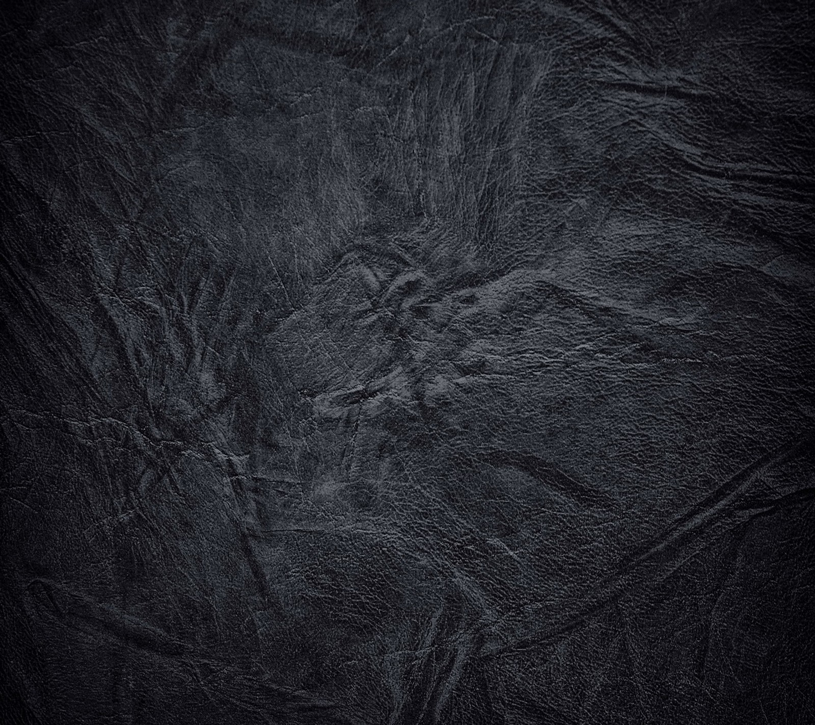 A close up of a black leather texture with a dark background (leather design, texture black abstract)