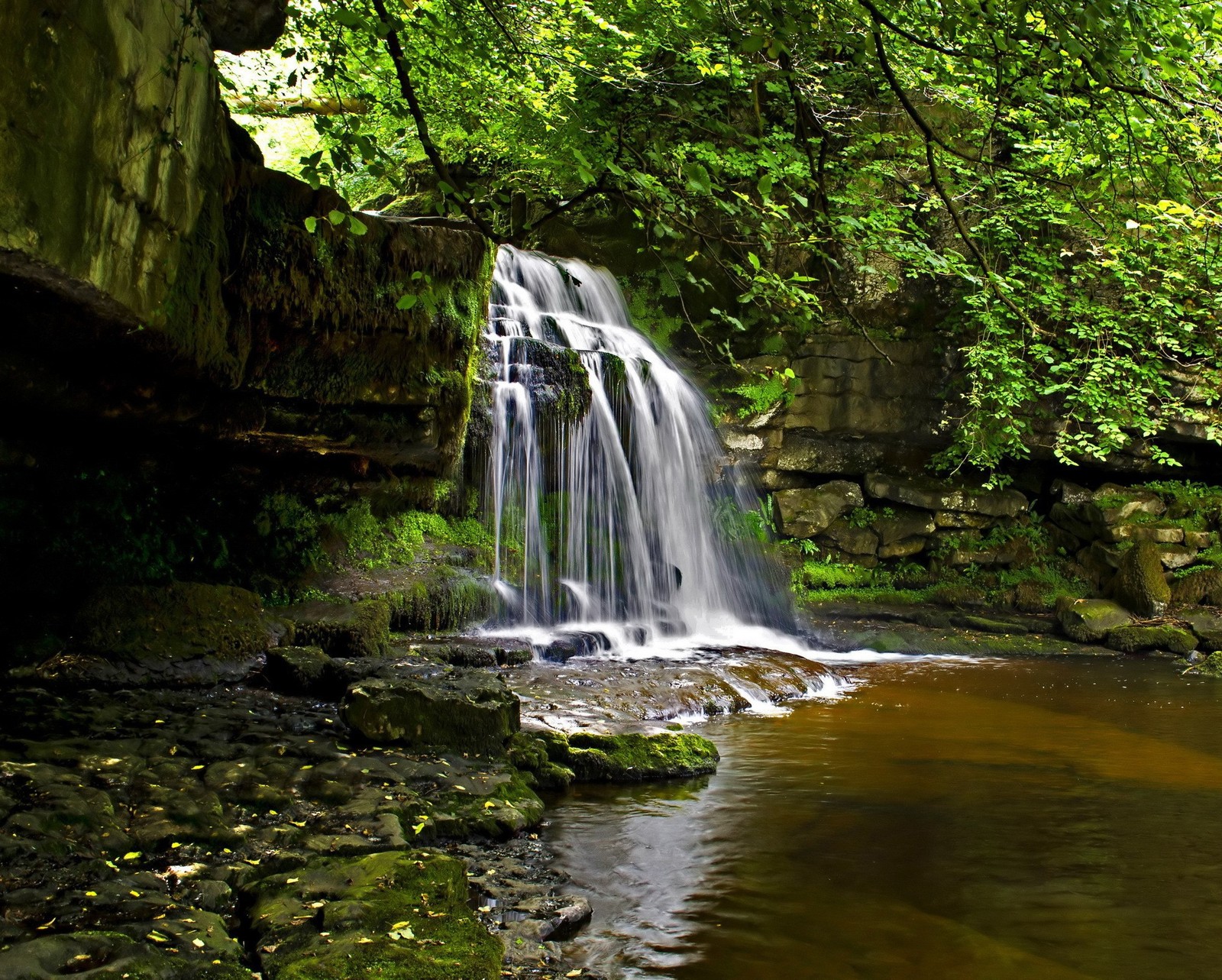 Waterfall in the woods with a large rock and a small stream (bridge, forest, nature, river)