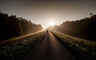 Solitary Figure Walking Along a Foggy Highway at Sunrise