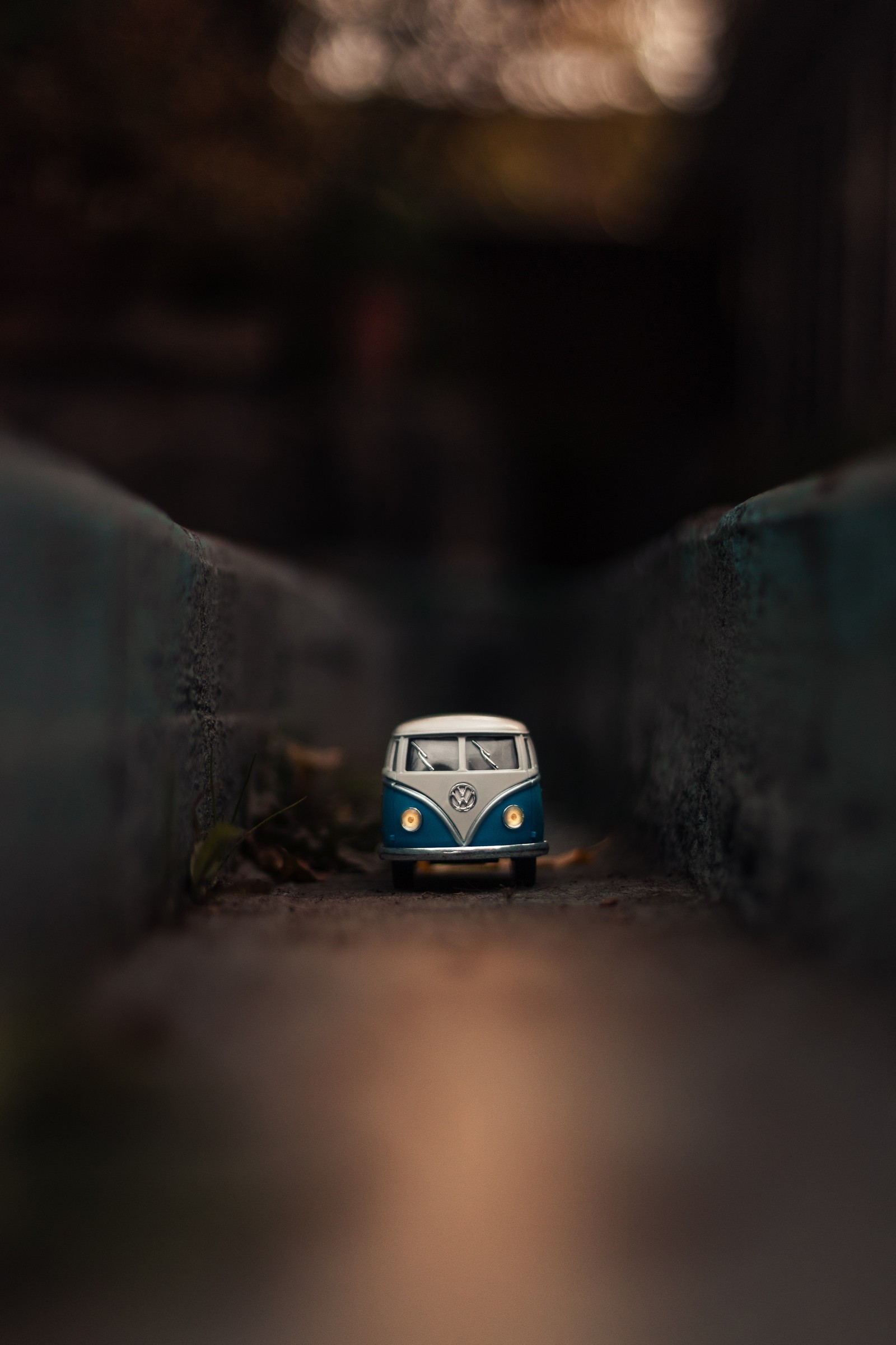 There is a toy van that is sitting on the ground (volkswagen type 2, car, volkswagen, blue, classic car)