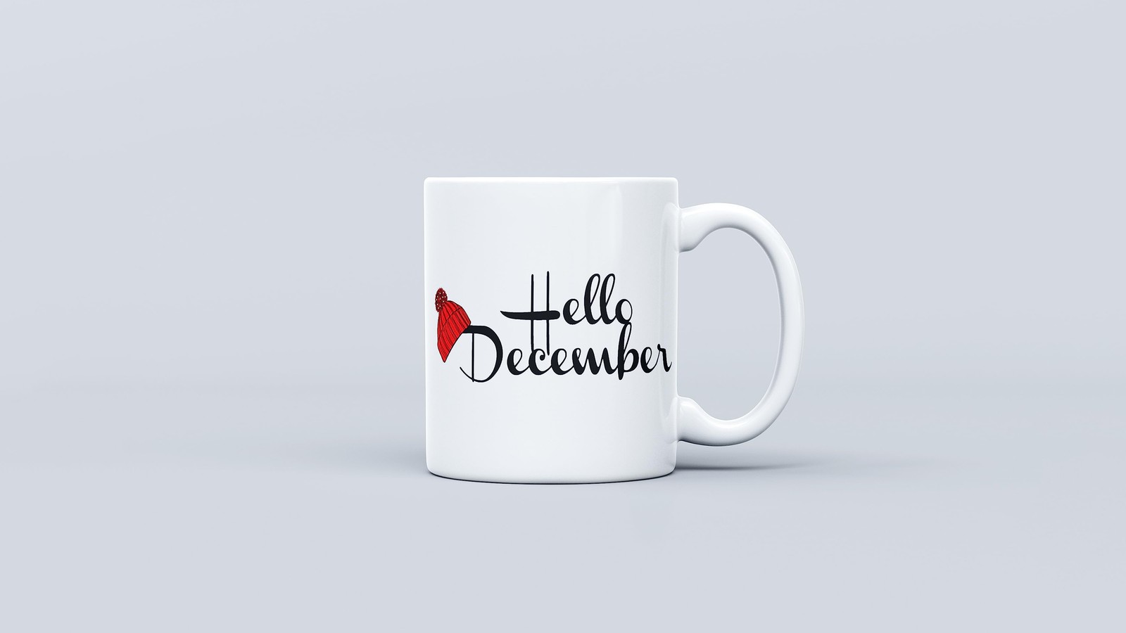 Une tasse de café blanche avec un nœud rouge et 'bonjour décembre' écrit dessus (bonjour décembre, tasses à café, fond blanc, noël, célébrations)